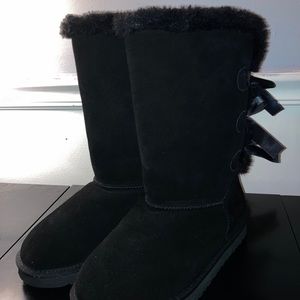 tall black UGG boots with bows on back